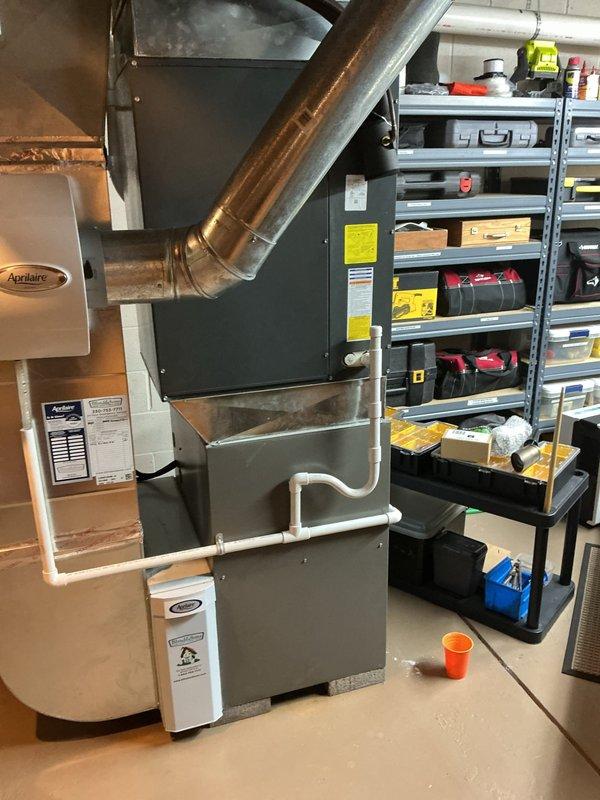 Responded to callback for water accumulation beneath furnace unit. Upon inspection, identified water leaking from PVC condensate drain piping and running down exterior of furnace cabinet. Inspected condensate drain system including pipe connections, elbow joints, and mounting brackets for signs of separation, cracks, or improper pitch that would cause drainage issues and water infiltration onto equipment and floor.