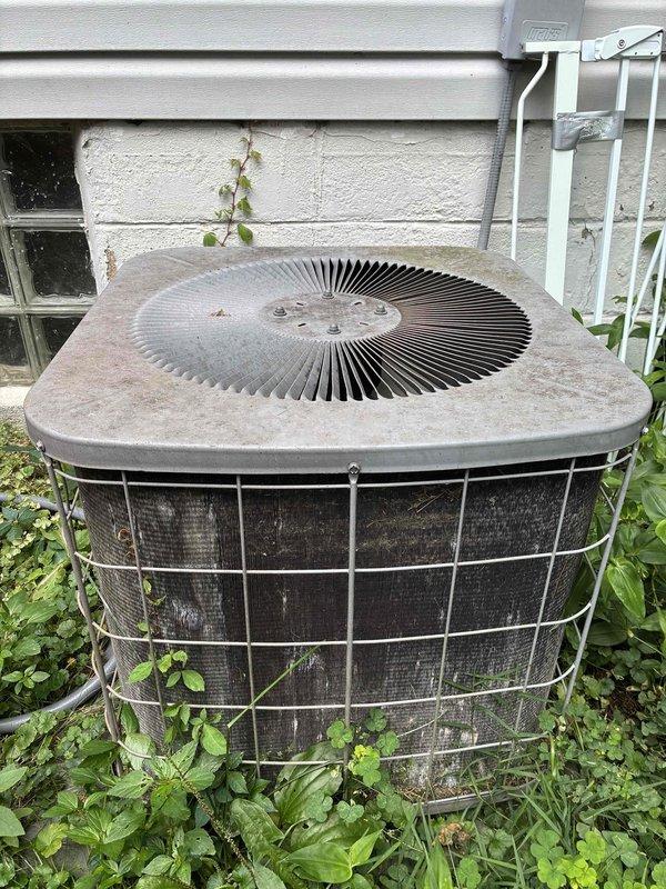 Completed BS-MVP cooling maintenance visit on an 18+ year old air conditioning system. Upon arrival, performed comprehensive inspection of outdoor condenser unit, which exhibited significant accumulation of dirt, debris, and organic matter throughout the coil fins, substantially restricting airflow and reducing system efficiency. Condenser coils were heavily soiled with dust, leaves, twigs, and grime buildup, indicating extended operation without proper maintenance. Vegetation growth around unit base was encroaching on equipment. Cleaned and serviced outdoor unit, removing debris from coils and restoring proper airflow. Additionally investigated furnace operation per customer request regarding loud knocking noise occurring when air conditioning system engages. Inspected furnace components and ductwork for potential issues related to thermal expansion, ductwork movement, or blower operation. Determined noise source and advised customer on findings. System operational upon completion of 
