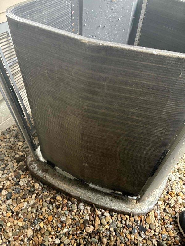 Completed routine maintenance tune-up on a 6-year-old outdoor condensing unit. Inspected condenser coils which showed moderate accumulation of dirt and debris on exterior fins, documented unit condition, and verified clean air filter at indoor air handler with proper pleating and structural integrity intact.