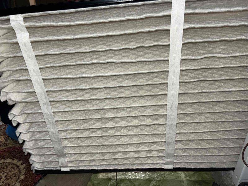 Completed routine maintenance tune-up on a 6-year-old outdoor condensing unit. Inspected condenser coils which showed moderate accumulation of dirt and debris on exterior fins, documented unit condition, and verified clean air filter at indoor air handler with proper pleating and structural integrity intact.