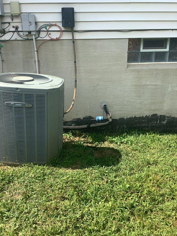 Completed on-site evaluation of 25-year-old HVAC system for replacement estimate. Assessed existing indoor furnace unit in basement utility area with associated PVC venting, ductwork connections, and electrical service, as well as outdoor Trane air conditioning condenser unit with refrigerant lines, electrical disconnect, and mounting configuration. Documented current system layout and conditions to provide comprehensive replacement recommendations.