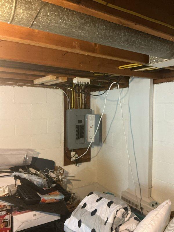 Responded to electrical short in hallway lighting circuit. Inspected electrical panel and wiring connections in basement utility area, traced circuit pathways through exposed joists, and identified faulty connection causing intermittent short. Repaired wiring defect, verified proper circuit operation, and confirmed all hallway lights functioning correctly without further issues.
