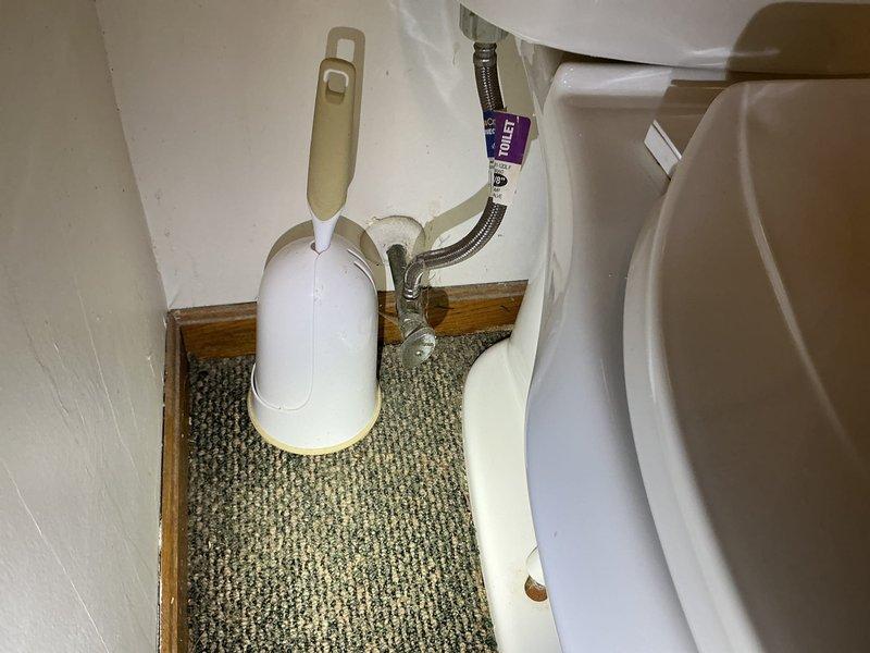 Responded to water leak at toilet base with visible pooling after flushing. Upon inspection, confirmed failed wax ring seal causing water to seep from beneath toilet bowl onto carpeted bathroom floor. Removed toilet, scraped old wax ring and flange residue, inspected closet flange for damage and proper mounting. Installed new wax ring with plastic horn, reset toilet with new closet bolts, torqued to manufacturer specifications, and reconnected water supply line. Tested multiple flush cycles to verify proper seal and confirmed no leakage at base. Advised customer on signs of future seal failure and recommended monitoring for any moisture.