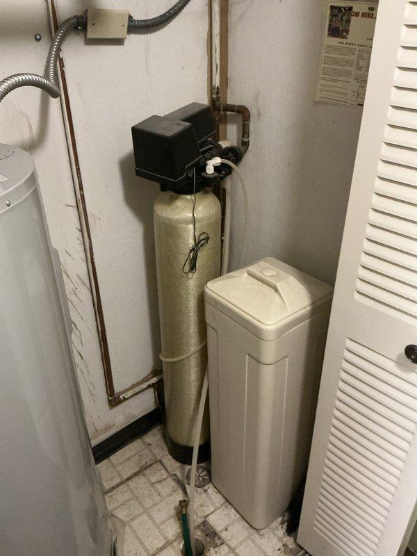 Conducted on-site assessment for 50-gallon electric water heater replacement. Evaluated existing unit installation in utility room, noting current plumbing connections with copper piping, electrical supply configuration, and clearance requirements. Documented water softener and brine tank proximity to ensure adequate workspace access for equipment removal and new unit installation. Provided comprehensive estimate covering complete water heater removal, disposal of old unit, and installation of replacement 50-gallon electric water heater with all necessary connections and code-compliant setup.