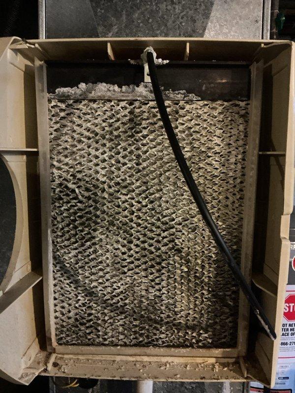 Completed cooling maintenance visit on 12-year-old Trane HVAC system. Upon arrival, customer was not home; access was rescheduled and gained for service completion. Performed standard preventive maintenance inspection including filter examination, which revealed heavy dust and debris accumulation on the mesh filter requiring attention. Inspected interior components, ductwork, and condensate drainage system with white PVC piping. All accessible components were evaluated for proper operation and wear. System operational at time of service completion.
