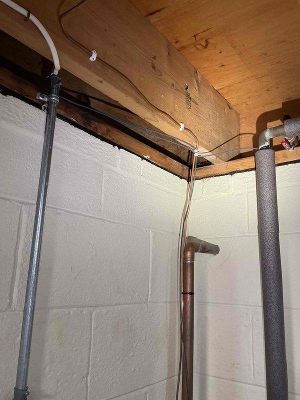 Installed Tesla electric vehicle charging station in garage along with additional electrical outlets. Ran new electrical conduit and wiring through basement utility area, utilizing existing infrastructure pathways along exposed joists and mechanical systems. All installations completed to code specifications with proper circuit protection and grounding.