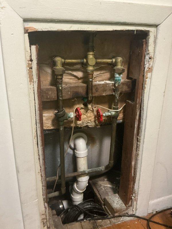 Replaced worn gaskets in the tub diverter valve assembly. Accessed the valve mechanism through the wall cavity behind the three-handle tub and shower fixture, removed the existing deteriorated gaskets, and installed new replacement gaskets to restore proper water flow control and eliminate leaks. Reassembled the valve components and verified proper operation of the diverter function.
