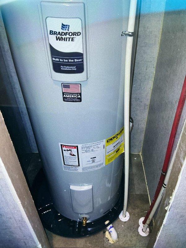 Replaced existing water heater with new Bradford White 40-gallon electric tank water heater in residential utility area. Installation included required code upgrades: installed thermal expansion tank on cold water supply line and new water shut-off valve. Configured copper piping system with proper connections, brass fittings, and shut-off valves throughout. Installed drain pan beneath unit for leak protection. Completed all electrical connections and verified proper operation of new system with 6-year warranty coverage.