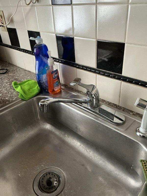 Responded to follow-up service call for kitchen sink faucet that was previously repaired for handle leak but developed a drip from the spout. Inspected chrome single-handle faucet and underlying plumbing connections. Identified source of dripping issue and performed necessary adjustments to resolve water seepage while confirming original handle leak repair remained intact.