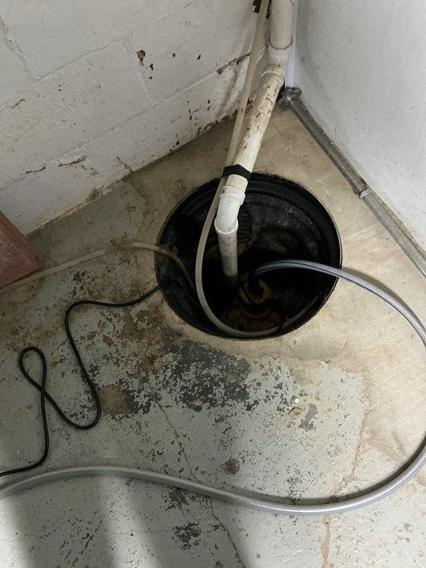 Responded to emergency service call for failed sump pump in residential basement with dual pump system. Removed and replaced non-functional 11-year-old sump pump unit with new pump from service vehicle inventory. Verified proper operation of replacement pump, tested discharge piping and check valve functionality, and confirmed secondary pump remained operational. System restored to full working capacity with both pumps now functional for adequate basement water management and flood protection.