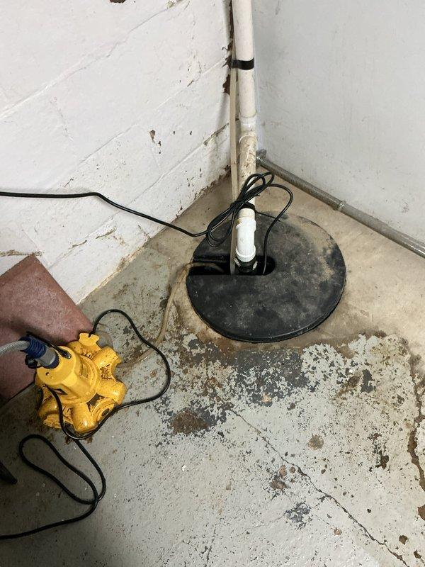 Responded to emergency service call for failed sump pump in residential basement with dual pump system. Removed and replaced non-functional 11-year-old sump pump unit with new pump from service vehicle inventory. Verified proper operation of replacement pump, tested discharge piping and check valve functionality, and confirmed secondary pump remained operational. System restored to full working capacity with both pumps now functional for adequate basement water management and flood protection.