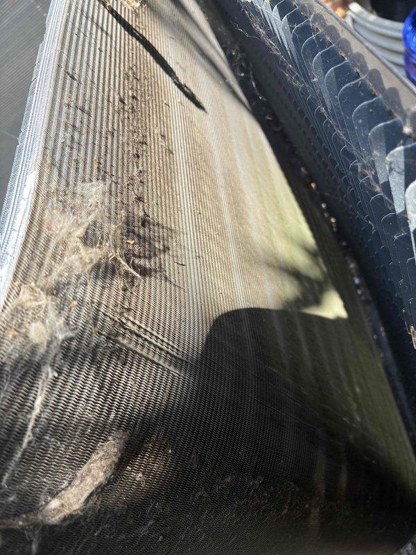 Performed routine maintenance on 6-year-old air conditioning system. Inspected evaporator coil and found significant accumulation of dirt, dust, and debris throughout the fin assembly, with heavy buildup particularly concentrated in upper sections that was restricting airflow. Conducted electrical diagnostics using clamp meter to verify system amperage and performance parameters at outdoor condensing unit. Measured capacitor values and confirmed proper electrical operation of compressor and fan motor circuits.