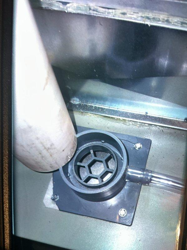 Responded to service call regarding smoke odor from return vent and furnace cycling issues after recent duct cleaning. Inspected HVAC system and identified moisture accumulation in condensate drain pan area with visible water staining on air handler surfaces. Evaluated thermostat malfunction causing unit to cycle independently of thermostat settings and installed non-digital replacement thermostat per customer request. Examined ductwork interior and return air pathways to locate source of smoke smell, finding residual particulate matter in system following duct cleaning service. Verified proper system operation, confirmed thermostat control functionality, and ensured no further odor issues from HVAC components.