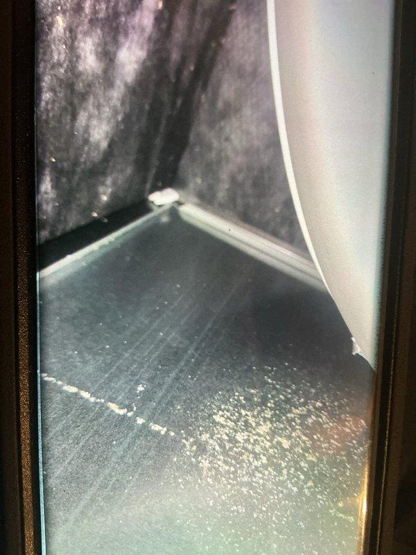 Responded to service call regarding smoke odor from return vent and furnace cycling issues after recent duct cleaning. Inspected HVAC system and identified moisture accumulation in condensate drain pan area with visible water staining on air handler surfaces. Evaluated thermostat malfunction causing unit to cycle independently of thermostat settings and installed non-digital replacement thermostat per customer request. Examined ductwork interior and return air pathways to locate source of smoke smell, finding residual particulate matter in system following duct cleaning service. Verified proper system operation, confirmed thermostat control functionality, and ensured no further odor issues from HVAC components.