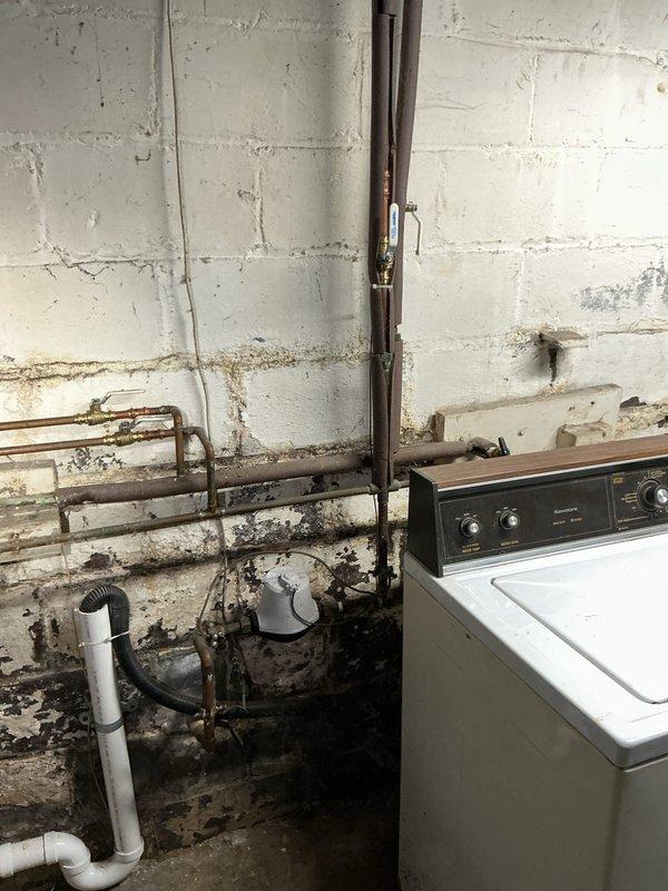 Installed two bathroom faucets in a century-old home with aging plumbing infrastructure. Removed existing corroded fixtures showing significant mineral buildup and rust deterioration around wall penetrations. Connected new faucets using flexible braided supply lines to existing copper stub-outs, addressing water staining and corrosion issues at connection points to ensure proper sealing and prevent future leakage.