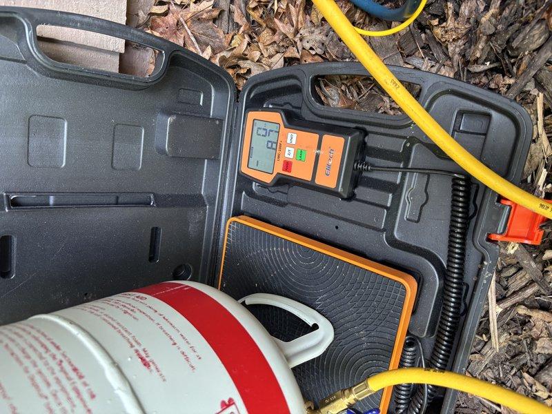 Completed annual cooling maintenance visit on one-year-old air conditioning system. Performed comprehensive system inspection, checked refrigerant levels and pressures using diagnostic gauges, and verified proper operation of all cooling components. Noted water heater in utility area showing signs of moisture accumulation at base with visible floor staining, which may require monitoring or future attention separate from the HVAC system maintenance.