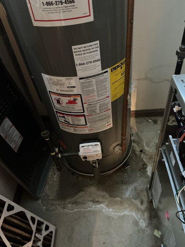 Completed annual cooling maintenance visit on one-year-old air conditioning system. Performed comprehensive system inspection, checked refrigerant levels and pressures using diagnostic gauges, and verified proper operation of all cooling components. Noted water heater in utility area showing signs of moisture accumulation at base with visible floor staining, which may require monitoring or future attention separate from the HVAC system maintenance.