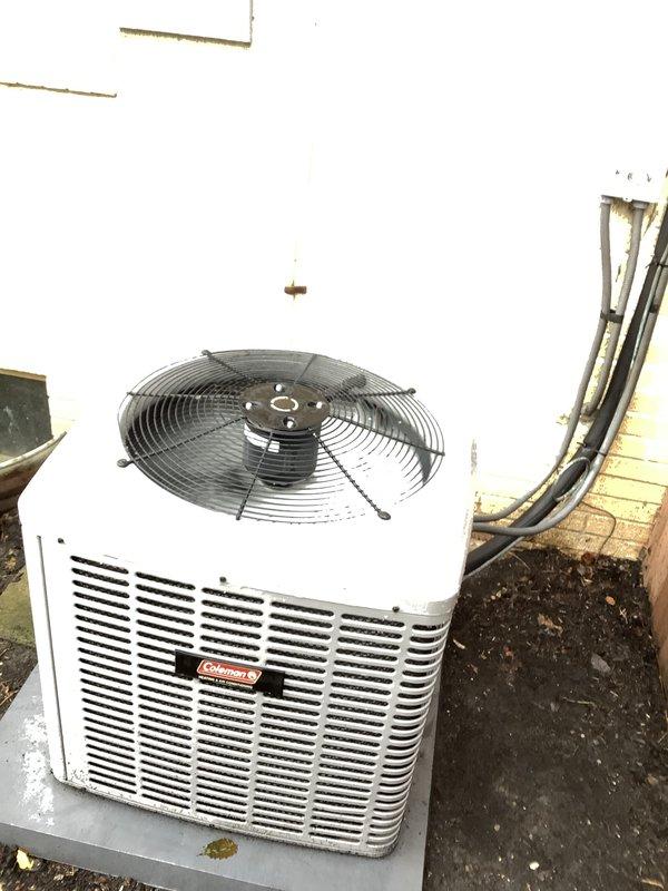 Conducted comprehensive HVAC system evaluation for complete replacement estimate. Assessed existing Coleman outdoor condensing unit mounted on concrete pad with refrigerant lines and electrical conduit routing along exterior wall. Inspected attic-mounted air handler system with associated ductwork, PVC condensate drainage, and electrical connections. Documented current equipment condition, installation configuration, and surrounding insulation integrity. Provided detailed replacement proposal for complete system upgrade.
