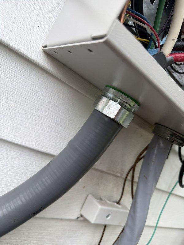 Completed warranty work to address failed inspection items on electrical installation. Glued all PVC conduit connections per code requirements, tightened neutral lugs in transfer switch to proper torque specifications, and sealed building penetration points to prevent water intrusion. Installed sealtight jacket under compression nut on exterior conduit entry, corrected SER cable support and strain relief in basement using appropriate connectors, and documented all corrections with photographs of transfer switch wiring, exterior conduit routing, and weatherproofing measures for re-inspection approval.