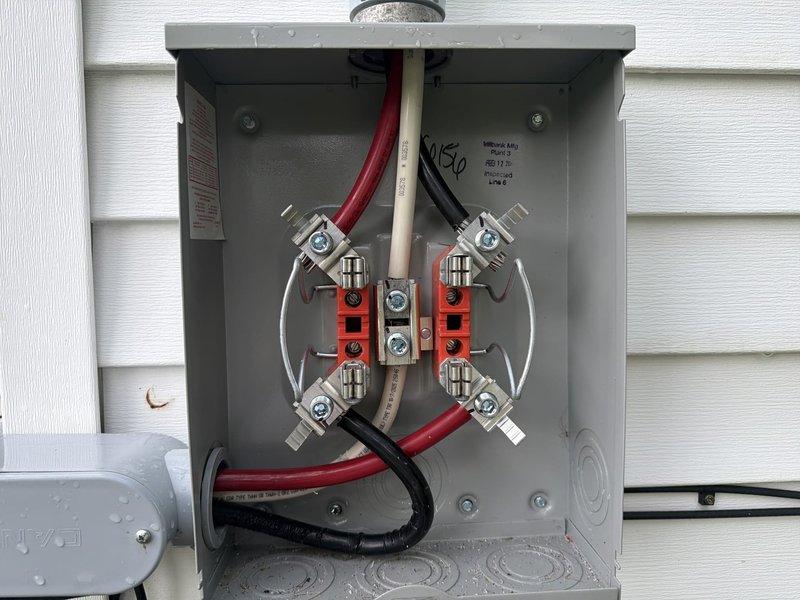 Completed warranty work to address failed inspection items on electrical installation. Glued all PVC conduit connections per code requirements, tightened neutral lugs in transfer switch to proper torque specifications, and sealed building penetration points to prevent water intrusion. Installed sealtight jacket under compression nut on exterior conduit entry, corrected SER cable support and strain relief in basement using appropriate connectors, and documented all corrections with photographs of transfer switch wiring, exterior conduit routing, and weatherproofing measures for re-inspection approval.