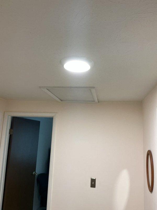 Replaced two existing light fixtures with modern LED recessed panel lights in the upstairs hallway and bedroom. Additionally, replaced a faulty GFCI receptacle in the upstairs bathroom to restore proper ground fault protection.