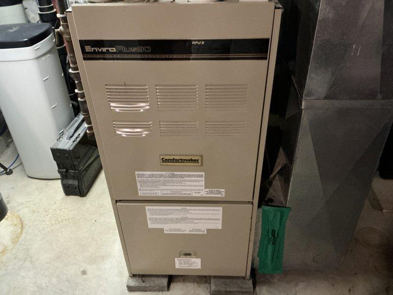 Conducted estimate for HVAC system replacement at residential property with 32-year-old Comfortmaker EnviroPlus80 furnace and existing outdoor AC condenser units. Previous AC replacement included only the outdoor unit, leaving aging furnace in service. Evaluated current equipment configuration including furnace, ductwork connections, and dual outdoor condensers positioned along exterior foundation. Provided comprehensive replacement quote covering furnace repair and system upgrade options to address equipment age and compatibility concerns with existing outdoor components.