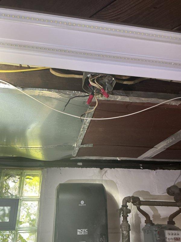 Responded to no power condition in basement room with no tripped breakers. Upon inspection, discovered improper DIY wiring installation in ceiling cavity near HVAC equipment. Located loose wire connections in junction box concealed above ductwork between floor joists. Secured all wire terminations, verified proper wire sizing and routing per NEC standards, and restored power to affected circuit. Tested all outlets and lighting in basement room to confirm full functionality. Recommended future evaluation of entire basement electrical system due to non-professional installation methods observed.