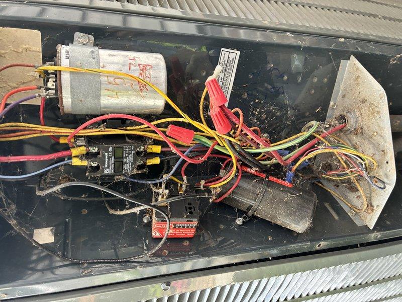 Completed annual maintenance on 13-year-old air conditioning system. Inspected electrical control panel, capacitor, and wiring connections; noted aging components with accumulated dirt and debris throughout assembly. Verified air filter condition, which showed minimal debris accumulation with pleated media intact and functioning properly.