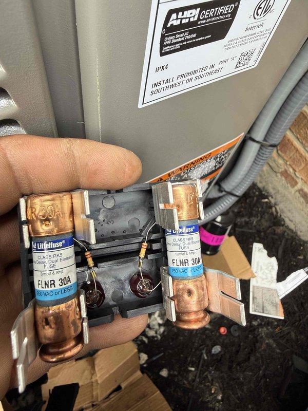 Completed installation of a new 90% efficiency furnace and air conditioning system. Installed indoor furnace unit with proper electrical connections including 30-amp Littelfuse FLNR fuses in the disconnect panel, and positioned outdoor AC condensing unit on prepared pad with decorative rock border. All refrigerant lines, electrical conduit, and control wiring were properly routed and secured, system was tested and verified operational per manufacturer specifications.