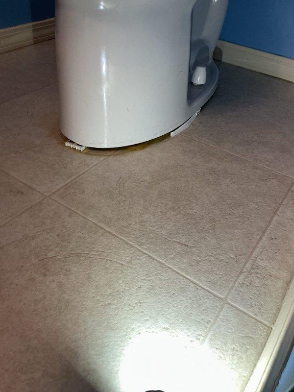 Responded to service call for reported toilet leak. Upon inspection, identified active water pooling on bathroom floor tiles near base of toilet fixture. Diagnosed leak source, performed necessary repairs to eliminate water seepage, and verified proper seal integrity. Toilet restored to normal operation with no further leakage detected upon completion of work.