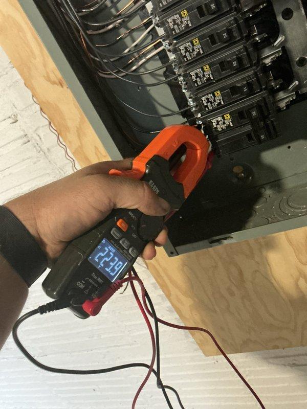 Completed installation of 480V AC circuit with new electrical panel and wiring. Installed circuit breakers, surge protection components, and properly terminated all conductors entering the panel from overhead conduit runs. Verified proper amperage readings using clamp meter to ensure circuit is functioning correctly and within specifications.