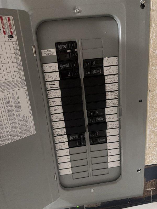 Completed warranty follow-up service addressing electrical code violations identified during inspection. Corrected improper neutral-ground bonding in main disconnect at transfer switch per NEC requirements. Downsized 20A breaker to 15A maximum for 14 AWG conductors to meet code specifications. Properly secured NM cables and flexible conduit per NEC 334.30. Closed open holes in electrical panel per NEC 110.12(A) and installed proper labeling on all disconnects per NEC 230.85. Ensured adequate clearance and illumination at transfer switch working space per NEC 110.26(B) and (D). Scheduled return visit post-inspection to install blank cover plate over wiring access hole and patch drywall opening created during installation, pending permit department approval and availability of patch kit materials.