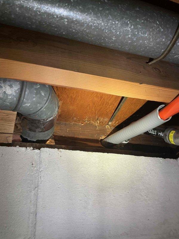 Installed new electrical outlet in residential space per customer request. Accessed ceiling cavity through crawl space to run electrical wiring from existing circuit to new outlet location. Routed cable through wooden joists alongside existing HVAC ductwork and plumbing infrastructure. Mounted outlet box in wooden ceiling near wall junction, made proper electrical connections, and secured outlet to code specifications. Verified circuit functionality and proper grounding upon completion.