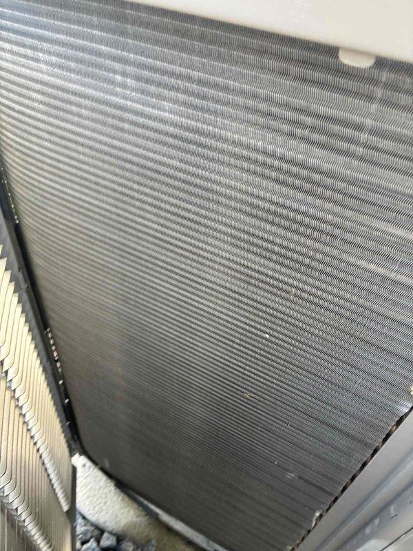 Completed preventive maintenance on 7-year-old residential air conditioning system. Inspected electrical disconnect panel, verifying all connections, contactor operation, and capacitor condition. Cleaned condenser coil fins and confirmed proper airflow through heat exchanger. All components operating within normal parameters upon completion of service.