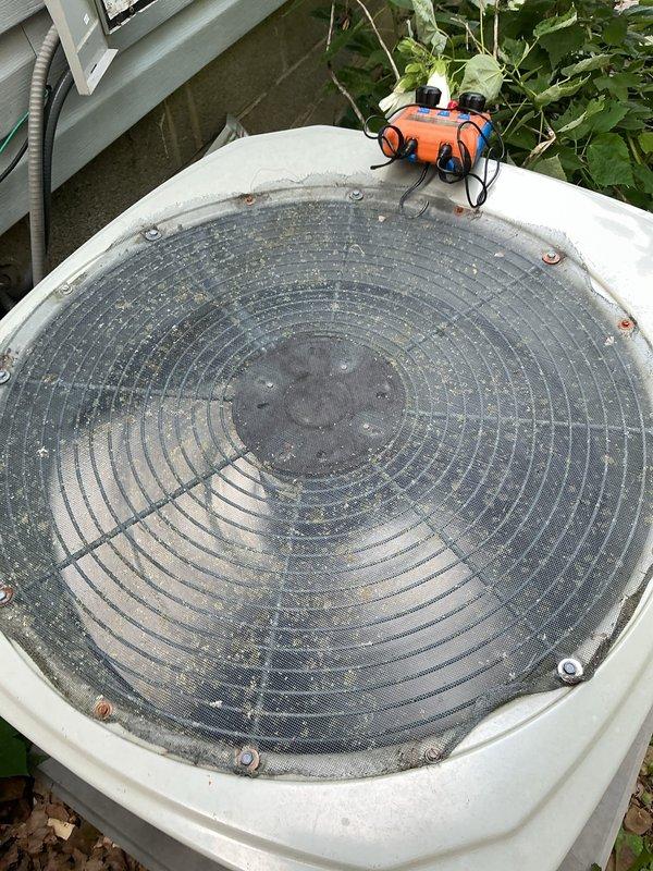 Responded to no cooling call for 12-year-old residential air conditioning system affecting entire home. Upon arrival, performed diagnostic evaluation of outdoor condensing unit. Utilized electronic testing equipment to assess system performance and operational parameters. Inspection revealed significant debris accumulation on condenser coil and protective grille, restricting airflow and reducing heat transfer efficiency. Documented equipment condition through photographic records showing exterior housing, drainage components, and overall unit placement. Assessed PVC condensate drain line connections and verified proper routing. Unit displayed signs of normal aging with surface weathering and environmental exposure consistent with outdoor installation. Completed system diagnostics and provided recommendations for restoring proper cooling operation.