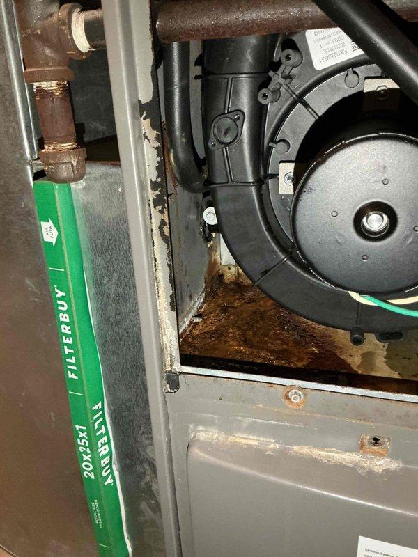 # HVAC Repair - Central Air Conditioner Ice Build-Up Resolution

Responded to service call for 15-year-old central air conditioning system experiencing ice accumulation during extended operation cycles. Upon arrival, contacted customer while en route as requested.

## Inspection and Diagnosis

Conducted comprehensive system evaluation to identify root cause of ice formation on evaporator coil. Accessed air handler unit and inspected internal components including blower motor assembly, evaporator coil section, and refrigerant lines. Documented existing conditions with photographic evidence showing:

- Corroded refrigerant line connections and mounting brackets with significant rust accumulation
- Aged insulation material on refrigerant lines showing signs of deterioration
- Blower motor assembly and housing in operational area
- 20x25x1 air filtration system configuration
- Overall equipment condition consistent with 15-year service life

Identified restricted airflow across evaporator 