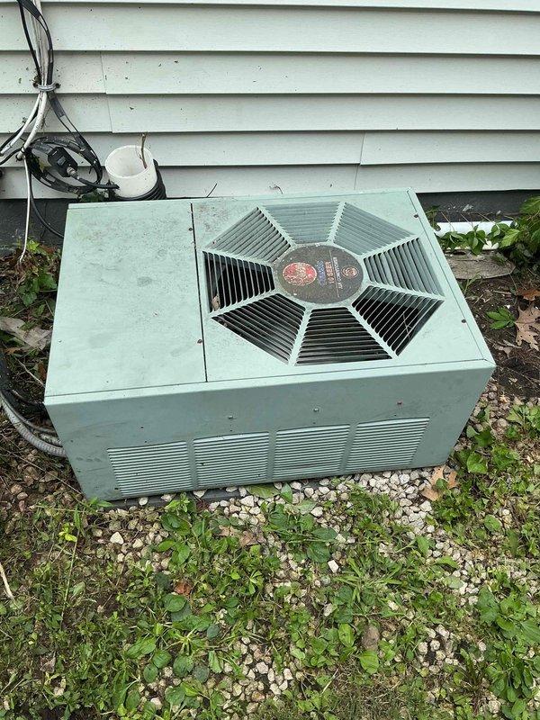 Responded to no cooling complaint on 34-year-old residential air conditioning system. Upon arrival, performed diagnostic inspection of outdoor condensing unit and electrical components. Unit showed significant age-related deterioration including corroded terminal connections, weathered wiring, and oxidized metal surfaces on the electrical junction area. The aging mint green condenser exhibited extensive wear consistent with three decades of outdoor exposure. After thorough evaluation of the electrical connections, compressor, and overall system condition, presented findings to customer. Due to the advanced age of the equipment and extent of component degradation, recommended system replacement rather than repair. Customer declined further service at this time.