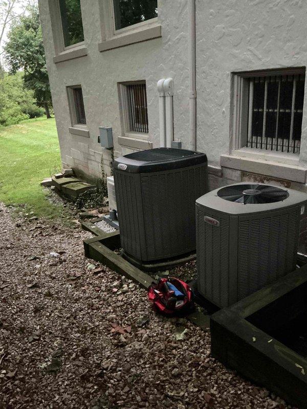 Completed routine preventive maintenance cooling visit on residential HVAC system. Serviced two exterior condensing units positioned on wooden platforms and inspected interior air handler unit with blower motor assembly. All equipment operating within normal parameters, system tested and confirmed functional.