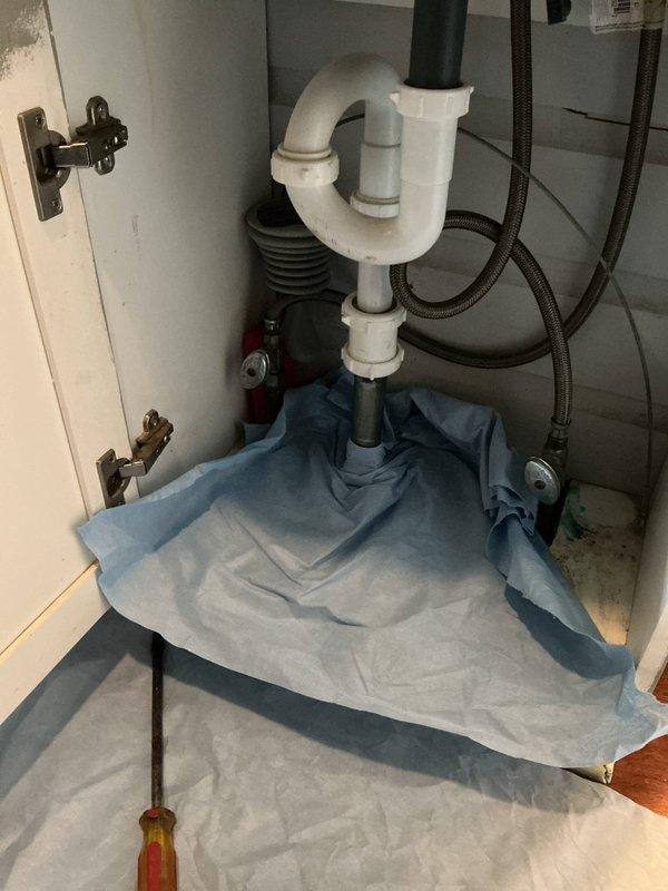 Responded to bathroom sink backup issue. Accessed P-trap assembly beneath sink and removed obstruction causing drainage problem. Disassembled P-trap piping, cleared accumulated debris and buildup from trap and drain line, then reassembled plumbing connections. Verified proper drainage flow and checked all connections for leaks. System restored to normal operation.