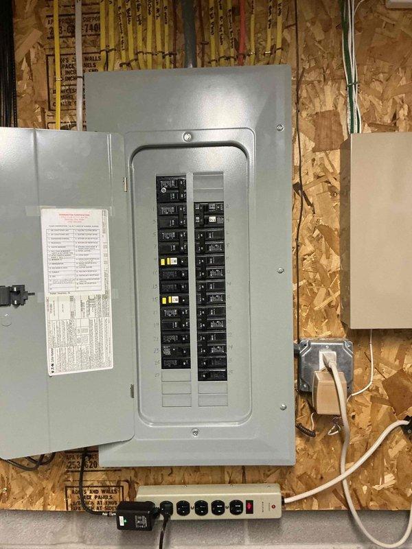 Completed residential generator installation estimate for existing customer. Confirmed natural gas availability to property and verified HOA approval for generator installation. Evaluated existing electrical panel configuration in unfinished utility area, documenting current breaker arrangement and available capacity for generator integration. Assessed exterior installation location adjacent to property fence line, noting adequate clearance from landscaping and structures. Photographed electrical service panel showing circuit layout and documented proposed generator placement area meeting required setback distances from building and property boundaries. Verified gas line accessibility and confirmed utility infrastructure capable of supporting standby generator system.