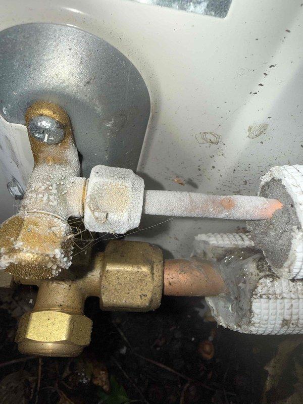 Responded to service call for non-operational Daikin mini-split system with no cooling. Upon inspection, discovered severe frost and ice buildup on refrigerant lines and valve assembly, indicating a refrigerant restriction or low charge condition causing the evaporator coil to freeze. Contacted technical support for diagnostic assistance, documented conditions with photos, and identified the need for further refrigerant system evaluation and potential leak repair.
