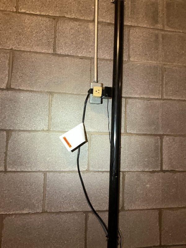 Installed battery backup system for existing sump pump to ensure continuous operation during power outages. The installation included mounting the backup battery unit adjacent to the sump basin, connecting the power supply and control wiring to the primary pump system, and integrating the discharge piping with the existing vertical PVC assembly that routes to the exterior drainage system.