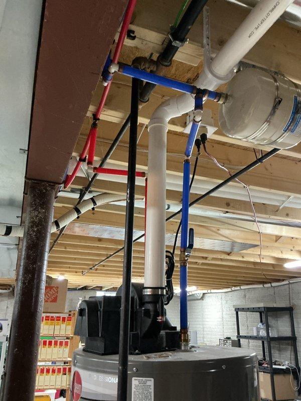 Conducted free estimate for tankless water heater replacement in residential property. Evaluated existing conventional tank water heater and surrounding plumbing infrastructure, including PVC supply lines, PEX tubing, and gas connections in ceiling space. Customer requested assessment for converting current system to tankless unit; existing tank water heater is currently functioning properly without issues.