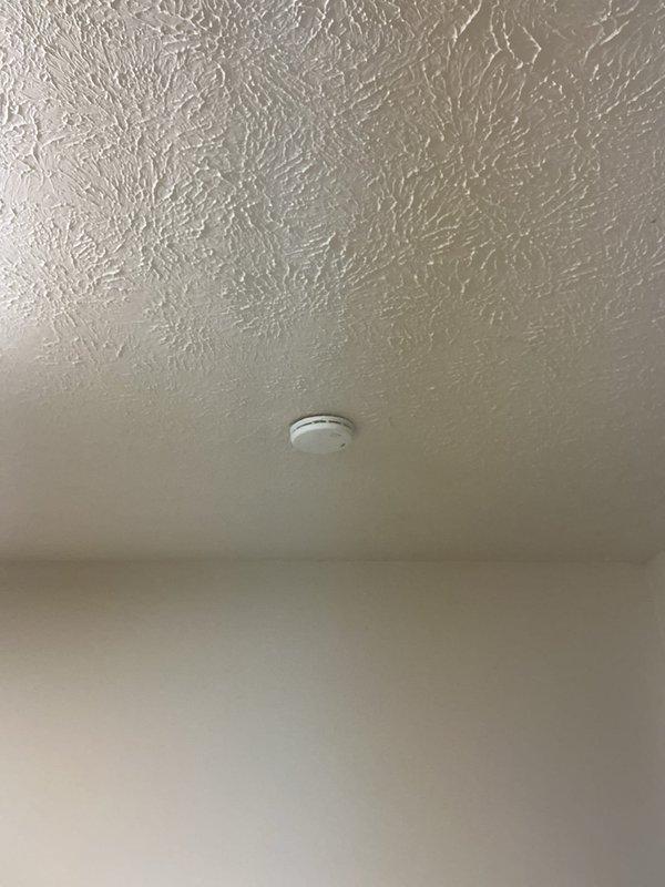 Replaced smoke detector on interior ceiling, ensuring proper mounting and functionality of new unit. Installed heat cables on exterior wall of TV room, routing conduit along building exterior and terminating in weatherproof junction box with appropriate cable connections for roof-mounted application.