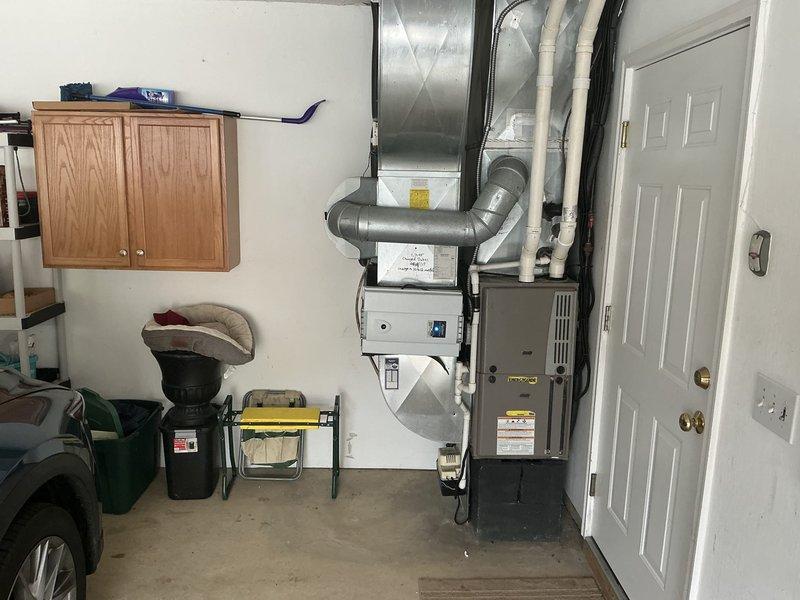 Completed comprehensive estimate for furnace and air conditioning system replacement. Evaluated existing Lennox outdoor condensing unit and indoor gas furnace installation in garage, documented current equipment condition and configuration through detailed site photography. Customer interested in BOGO half-off promotion; left message to confirm discount eligibility and finalize replacement proposal.