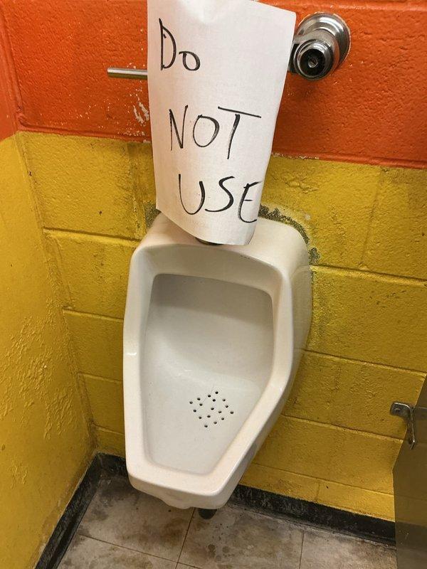 Responded to commercial plumbing service call for multiple fixture issues including urinal, toilet, and shut-off valve failures. Inspected Flushmate pressure-assisted toilet system (Model 503, 1.6 gpf) and found component requiring attention. Tagged non-functional urinal with out-of-service notice to prevent use until repairs completed. Assessed shut-off valves and identified additional plumbing components needing replacement to restore full functionality to restroom facilities.