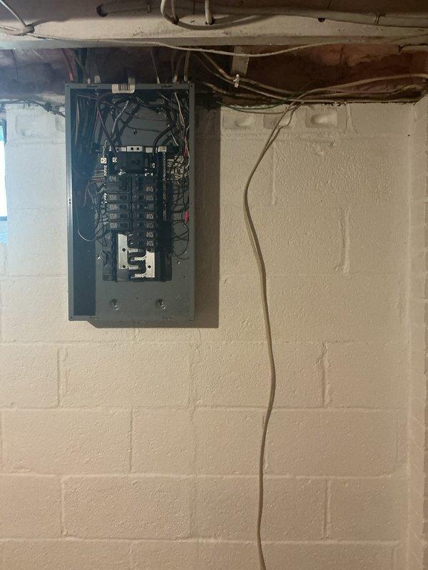 Responded to service call for electrical wiring installation into main breaker panel. Upon arrival, accessed existing electrical panel in basement utility area and successfully integrated new circuit by connecting beige electrical cable to appropriate breaker position. Routed wiring along wall and through ceiling joists in accordance with code requirements, ensuring proper support and protection of conductors. Verified all connections were secure, tested circuit functionality, and closed panel cover upon completion.