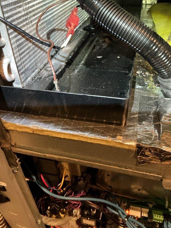 # Geothermal Cooling System Diagnostic and Inspection

Responded to service call for cooling issue on five-year-old geothermal heat pump system. Upon arrival, performed comprehensive system diagnostic to identify source of cooling malfunction. Removed access panel to inspect internal electrical components and control board assembly. Visually examined all wire connections, harnesses, and electrical terminations for signs of loose connections, corrosion, or damage. Control board and electrical components appeared intact with proper wire routing and secure connections.

Inspected heat exchanger coil assembly and refrigerant lines for potential issues. Examined copper tubing connections and coil condition, noting some discoloration consistent with normal system age. Checked drain pan and condensate management system, observing accumulated dust and debris typical of equipment requiring routine maintenance. Inspected flexible ductwork connections and verified proper securing with fasteners.
