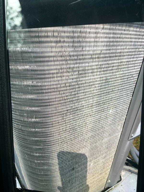 Completed routine cooling maintenance visit on 9-year-old air conditioning system. Inspected evaporator coil and found significant accumulation of dirt, dust, and debris on fins, though coil structure remained intact. Verified electrical components and capacitor connections within control panel, confirming all wiring and terminals secure and operational.
