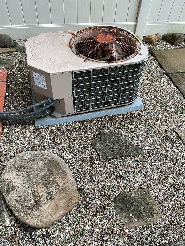 Completed MVP cooling maintenance visit on residential heat pump unit of unknown age. Performed standard preventive maintenance inspection of outdoor condenser unit, which exhibited significant rust and corrosion on top-mounted fan guard assembly and center hub components due to prolonged weather exposure. Unit remains operational with all major components functioning, though exterior metal surfaces show advanced oxidation typical of aged outdoor HVAC equipment.